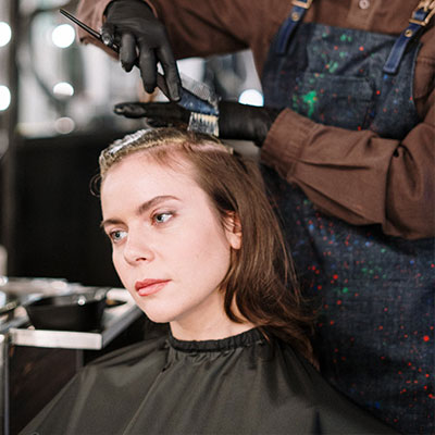 Professional mobile hairdresser in Derby performing hair colouring at a client’s home