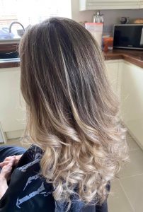 Mobile hairdresser in Derby performing a hair highlights service at home